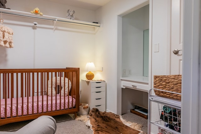 carpeted bedroom with a crib