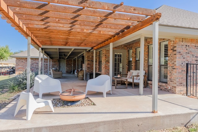 view of patio / terrace with an outdoor living space with a fire pit and a pergola