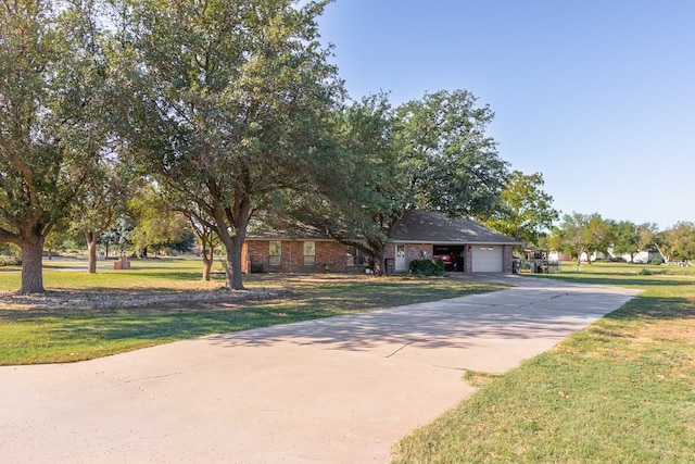 view of front of home with a garage and a front lawn