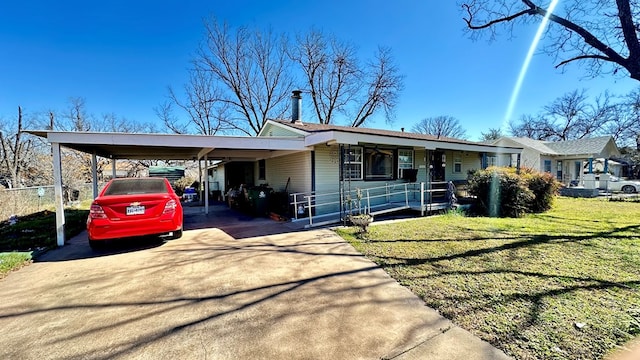 view of front of house with driveway, a front lawn, and a carport