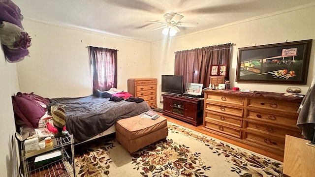 bedroom featuring ornamental molding and a ceiling fan