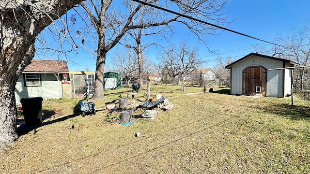 view of yard with an outbuilding and a shed