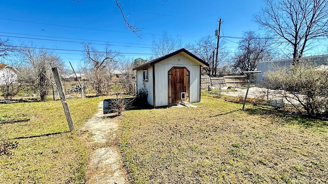 view of shed featuring fence