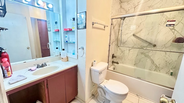 bathroom featuring toilet, shower / bath combination with glass door, and vanity