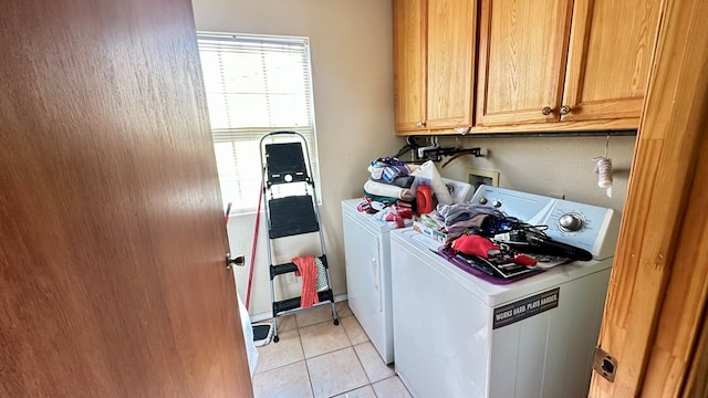 washroom featuring cabinet space, light tile patterned floors, and independent washer and dryer