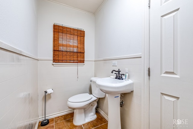 bathroom with crown molding, tile patterned floors, and toilet