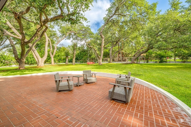 view of property's community with a yard and a patio