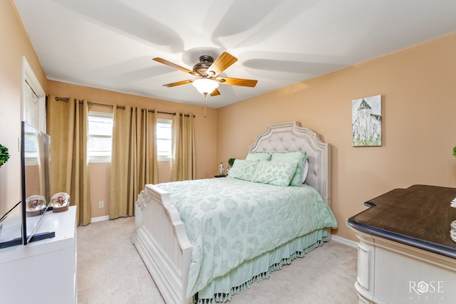 bedroom featuring ceiling fan and light carpet