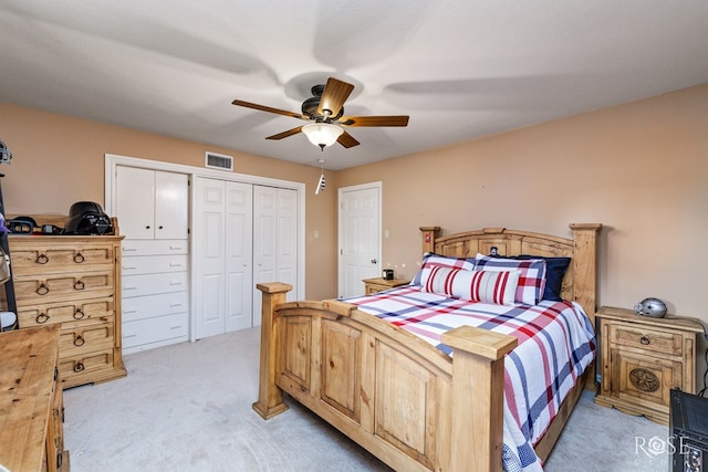 bedroom featuring light carpet and ceiling fan