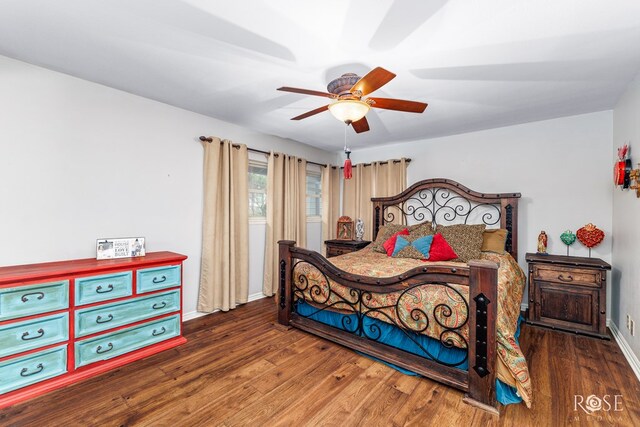 bedroom with ceiling fan and dark hardwood / wood-style floors