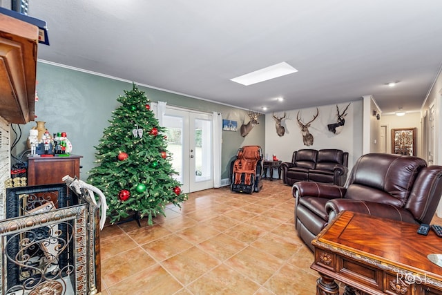 living room featuring french doors, crown molding, a skylight, and light tile patterned flooring