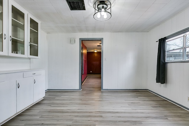 512 Ave J, Ozona, TX 76943 - unfurnished dining area featuring light wood-type flooring and visible vents