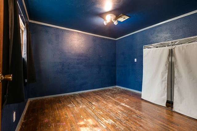 512 Ave J, Ozona, TX 76943 - unfurnished room featuring crown molding, hardwood / wood-style flooring, a textured wall, and baseboards