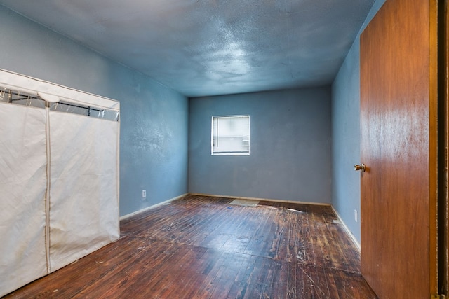 512 Ave J, Ozona, TX 76943 - spare room featuring baseboards and wood-type flooring