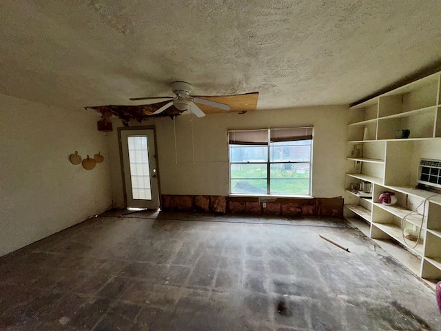 interior space featuring a textured ceiling and a ceiling fan