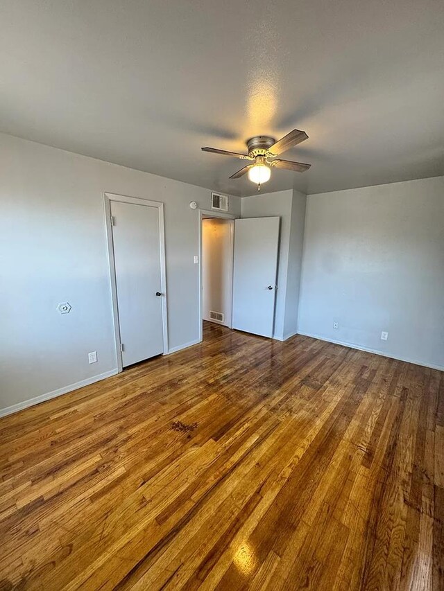 unfurnished bedroom with hardwood / wood-style flooring and ceiling fan