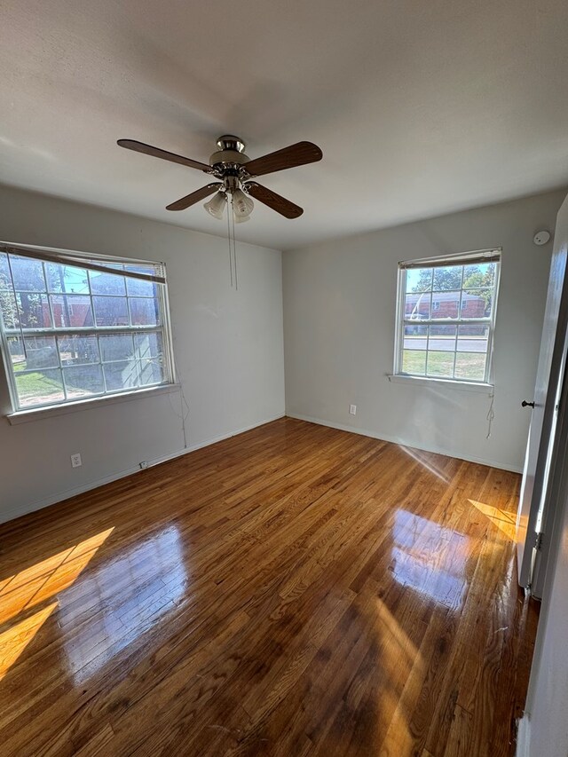 empty room featuring hardwood / wood-style flooring and ceiling fan