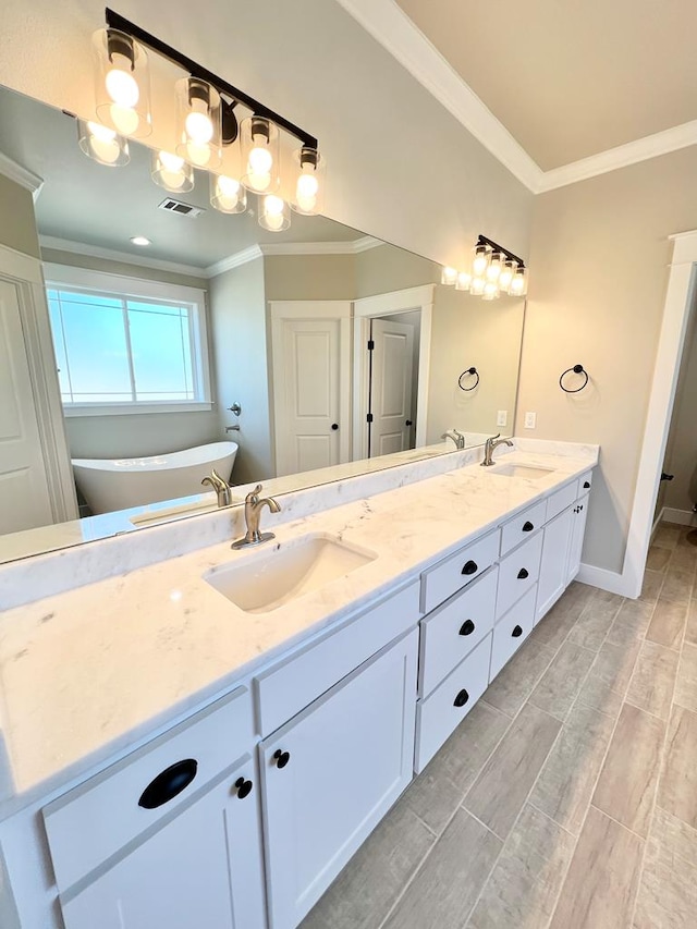 bathroom featuring a tub to relax in, ornamental molding, and vanity