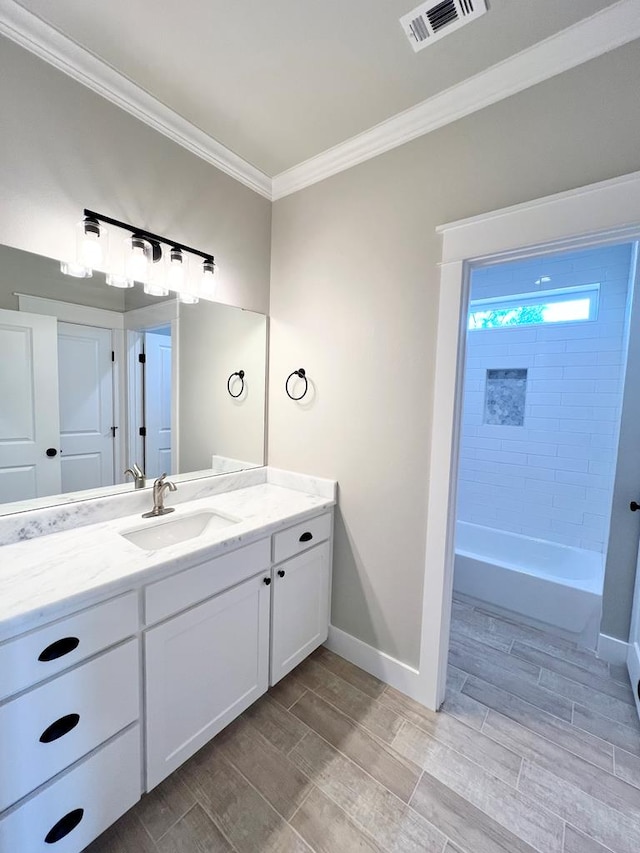 bathroom with vanity, tub / shower combination, and ornamental molding