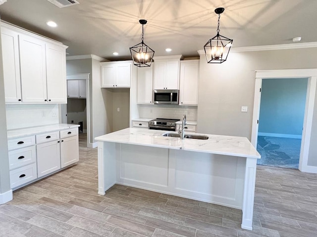 kitchen with sink, pendant lighting, stainless steel appliances, a kitchen island with sink, and white cabinets