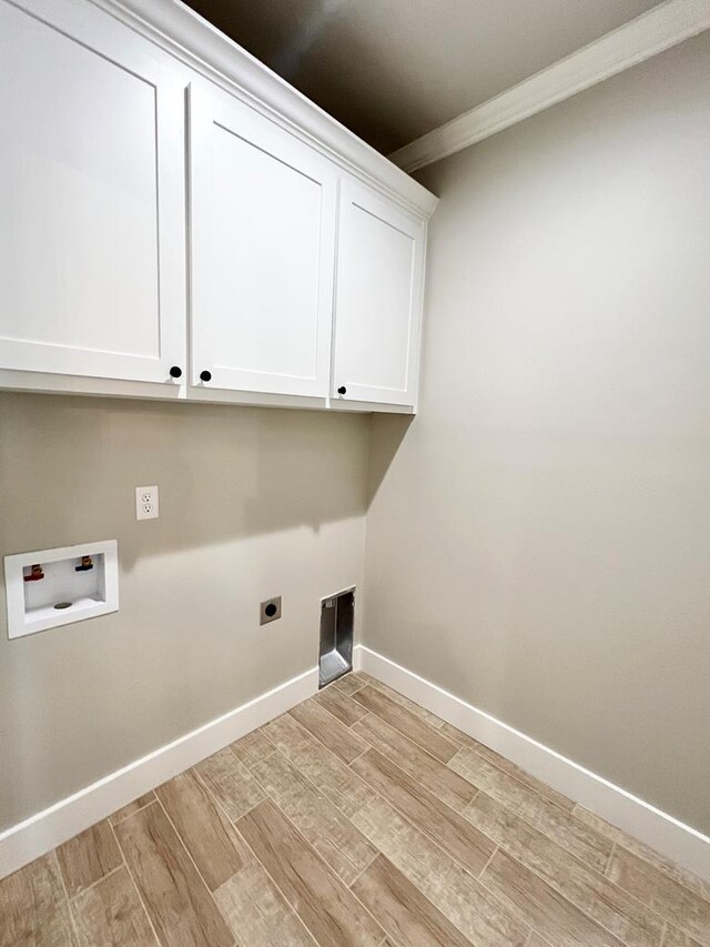 laundry room with cabinets, washer hookup, light hardwood / wood-style floors, ornamental molding, and hookup for an electric dryer