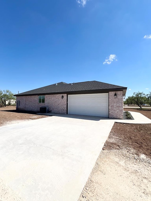 view of front of house with central AC unit and a garage