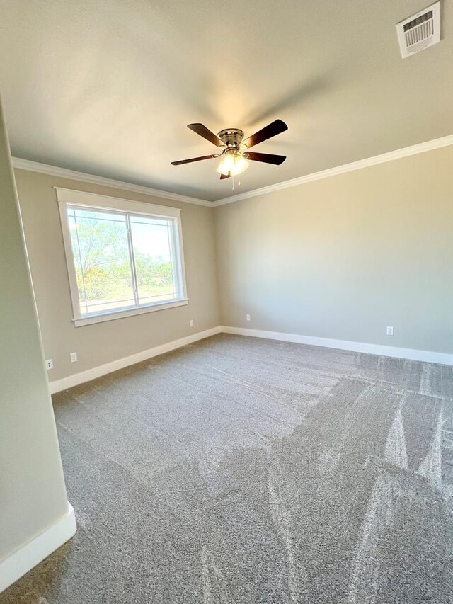 carpeted empty room with crown molding and ceiling fan