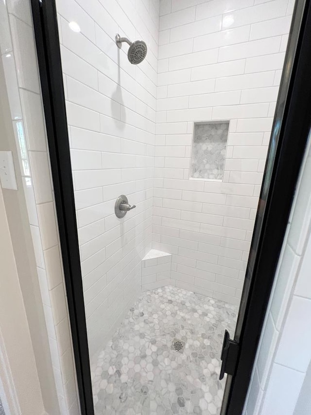 bathroom with a tile shower