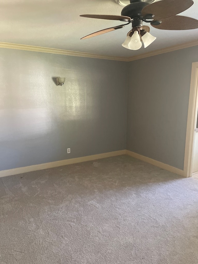 carpeted spare room featuring crown molding and ceiling fan