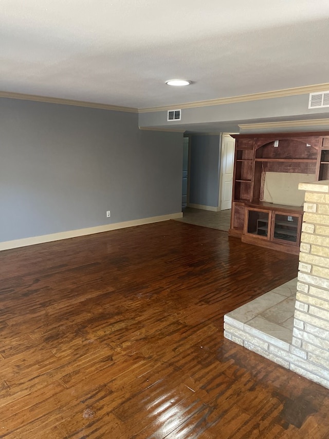 unfurnished living room with ornamental molding and dark hardwood / wood-style floors