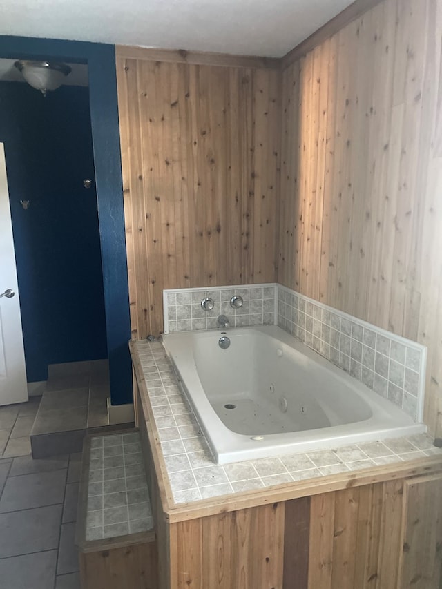 bathroom with tile patterned flooring and a bathtub