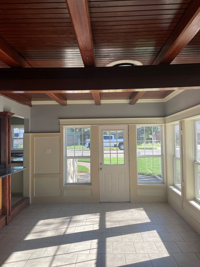 unfurnished sunroom with beamed ceiling