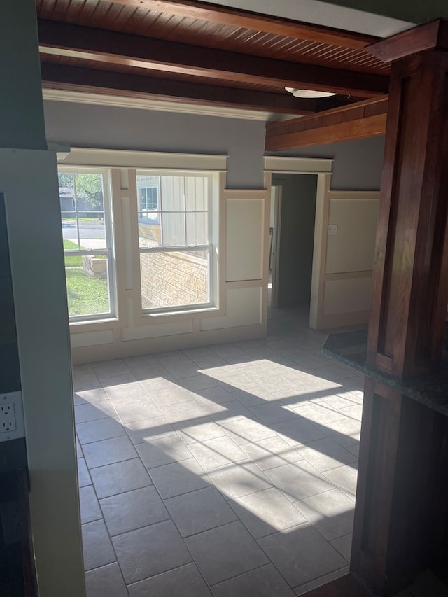 spare room featuring beamed ceiling and wooden ceiling