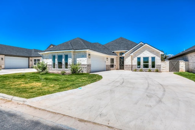 view of front facade with a garage and a front lawn