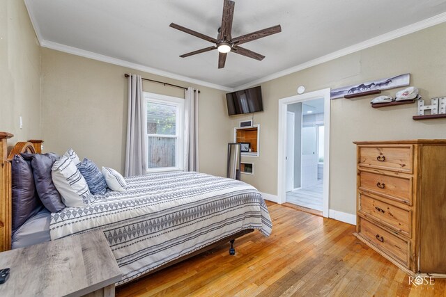 bedroom with wood-type flooring, crown molding, connected bathroom, and ceiling fan