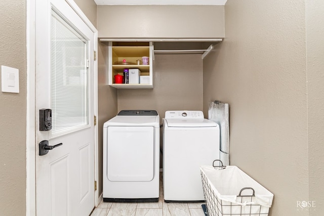 clothes washing area featuring washer and dryer