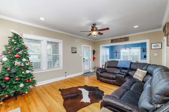 living room with crown molding, hardwood / wood-style floors, and ceiling fan