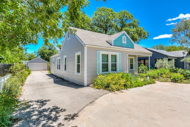 view of home's exterior with a garage and an outbuilding