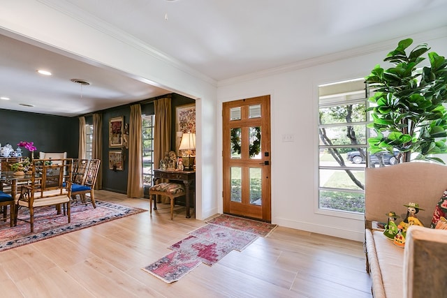 2121 Sul Ross St, San Angelo, TX 76904 - foyer with healthy amount of natural light, light wood finished floors, ornamental molding, recessed lighting, and baseboards