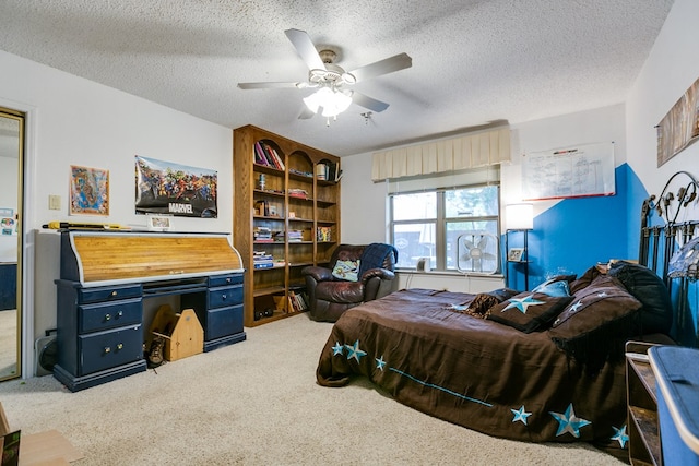 carpeted bedroom with ceiling fan and a textured ceiling