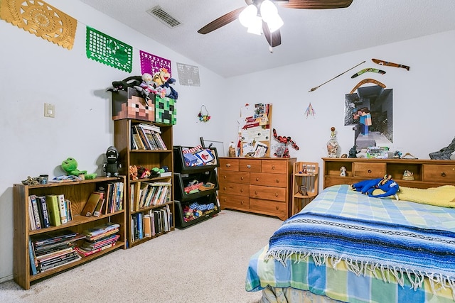 carpeted bedroom featuring lofted ceiling, a textured ceiling, and ceiling fan