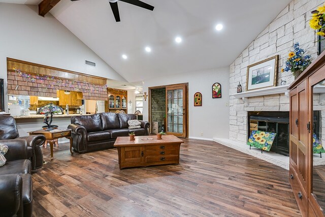 living room with a fireplace, dark hardwood / wood-style flooring, high vaulted ceiling, and beam ceiling