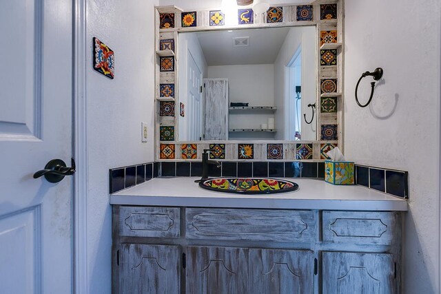 bathroom with vanity and backsplash