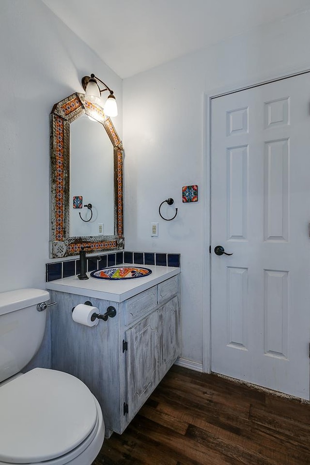 bathroom featuring vanity, hardwood / wood-style floors, and toilet