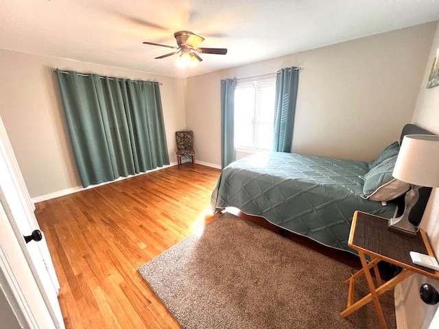 bedroom with wood-type flooring and ceiling fan