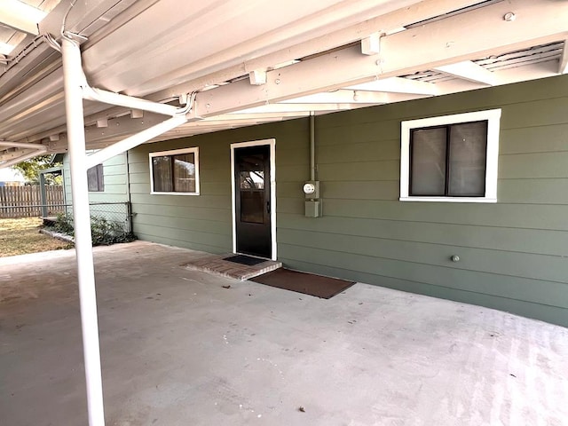 view of exterior entry with a patio