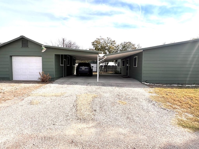 view of vehicle parking featuring a carport and a garage