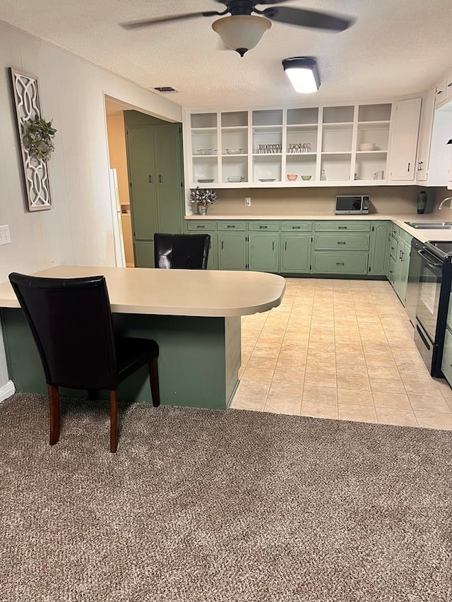 kitchen featuring white cabinetry, sink, black electric range oven, green cabinets, and light tile patterned floors