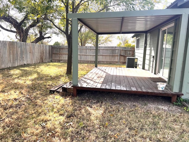 deck with a yard and central air condition unit