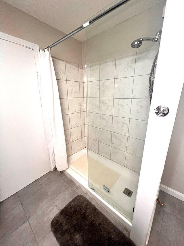 bathroom featuring tile patterned floors and curtained shower